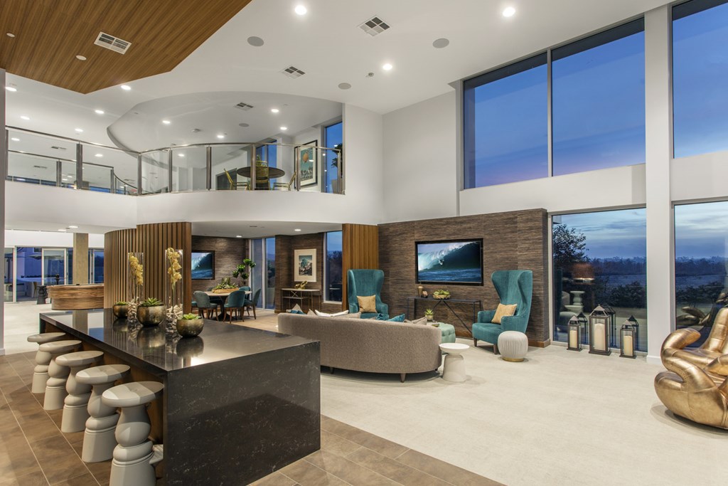 a large living room with a large table and chairs